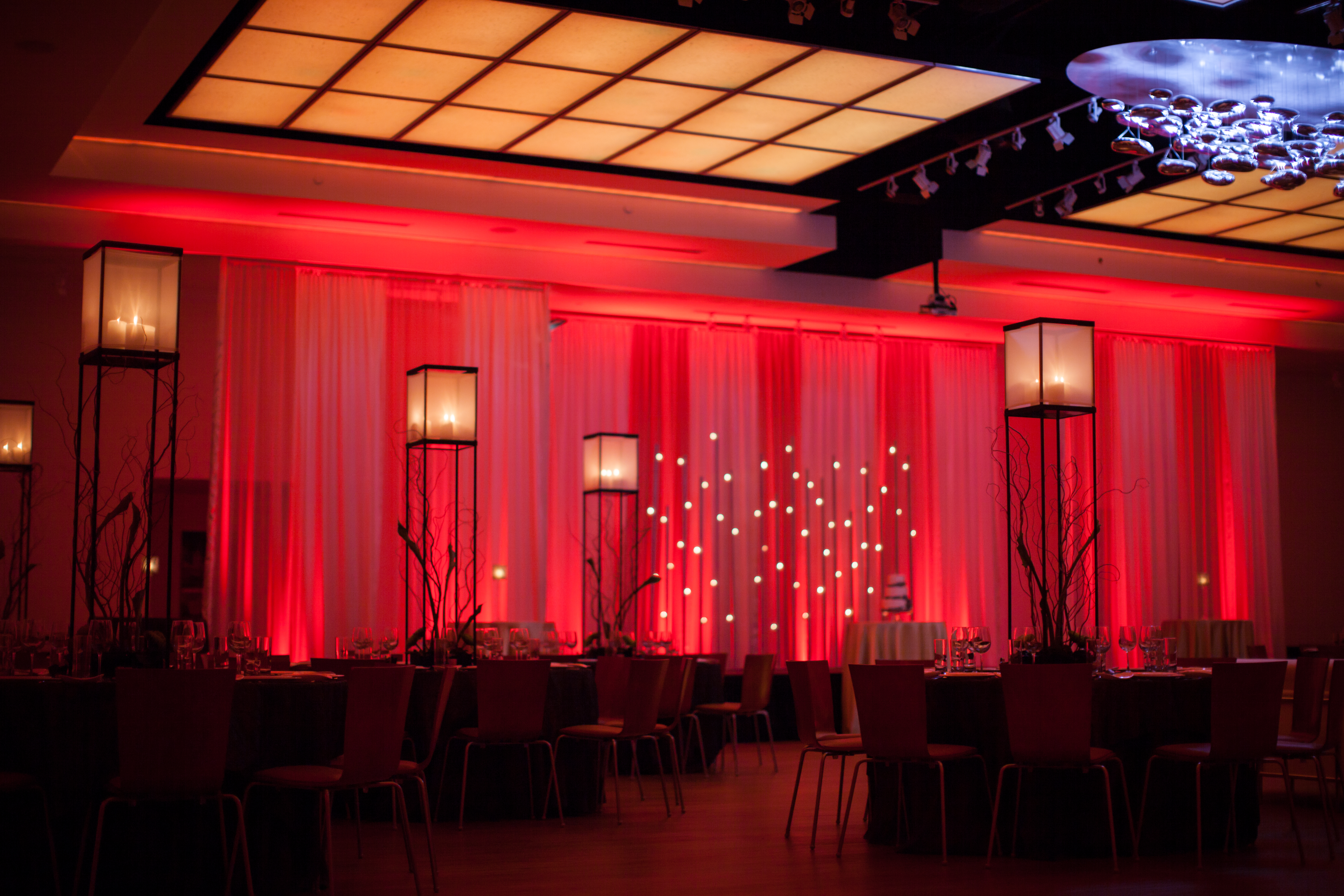 Unique setup at The Gallery featuring red wash light and dim lamps.