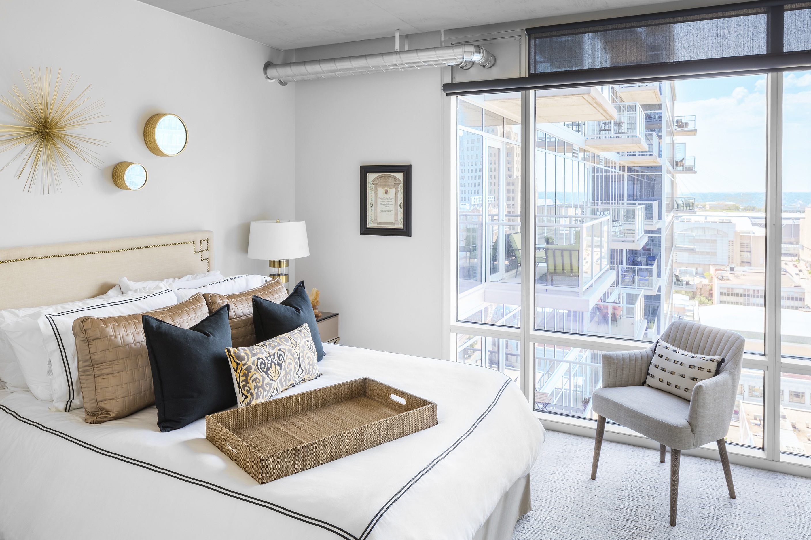 City view from bedroom with floor-to-ceiling windows at Two Light luxury apartment in Kansas City, MO.