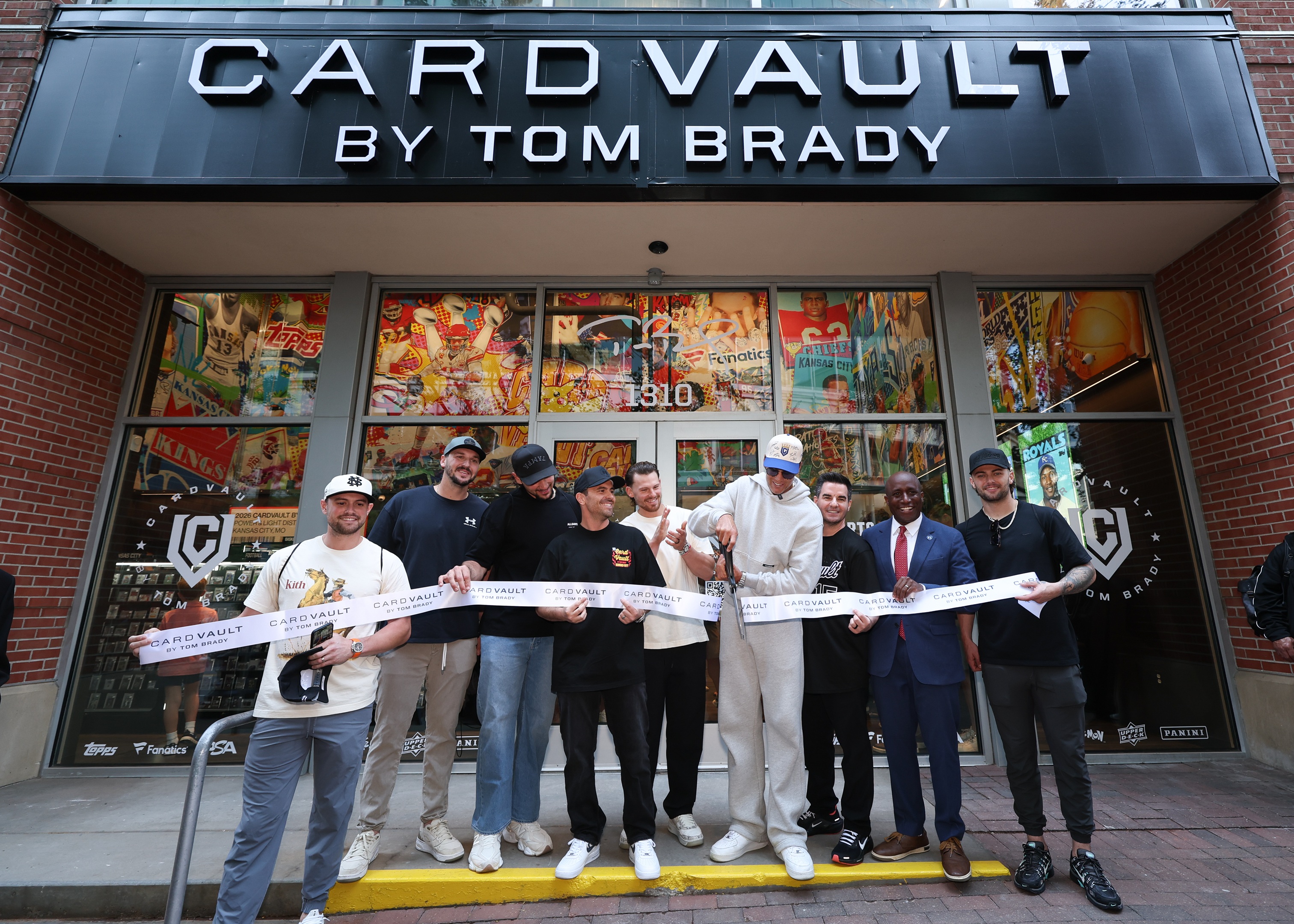 Tom Brady and others cutting ribbon at CardVault opening.