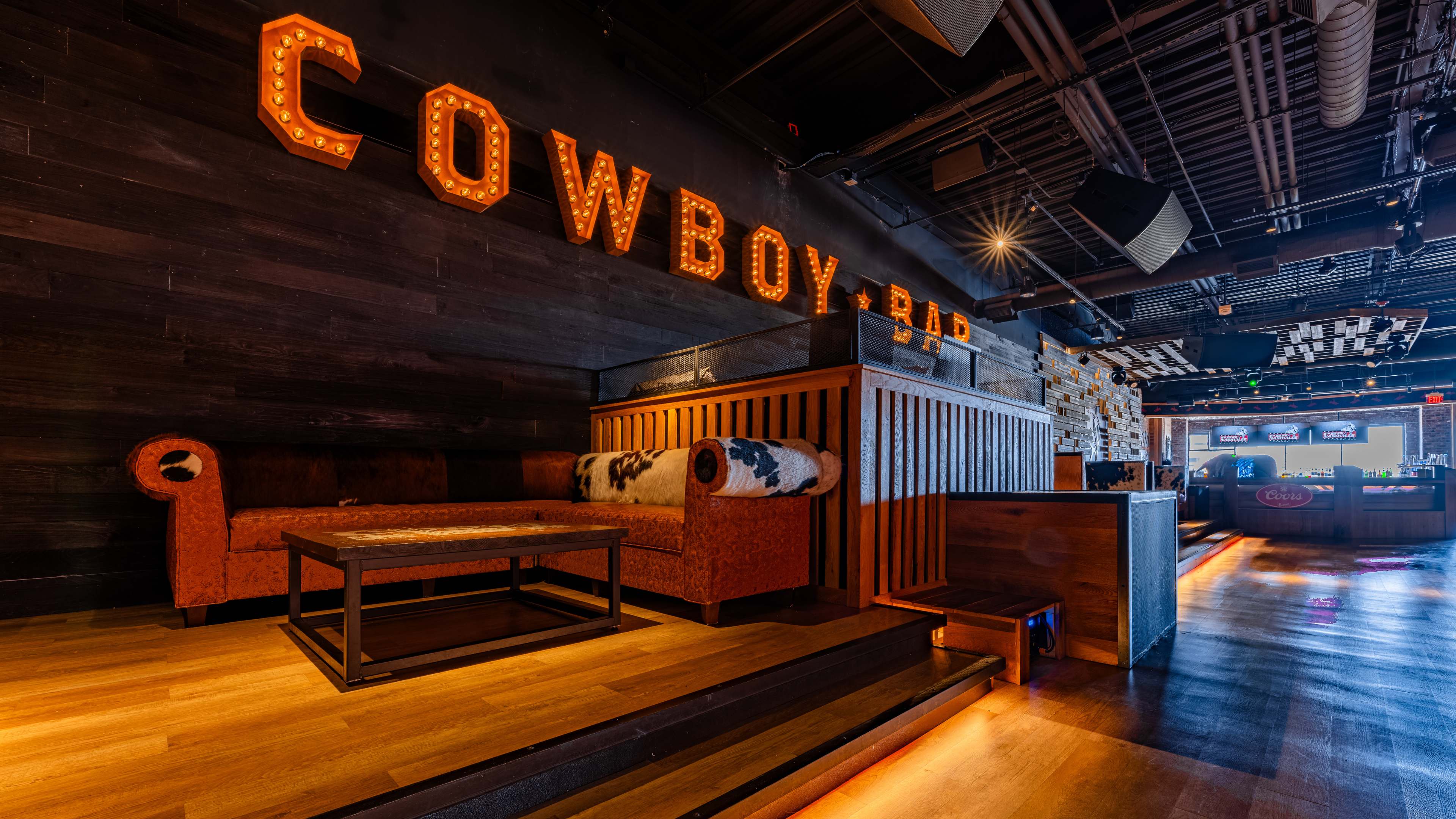 Dance floor, booth seating, and DJ booth at PBR Cowboy Bar Nashville, TN.