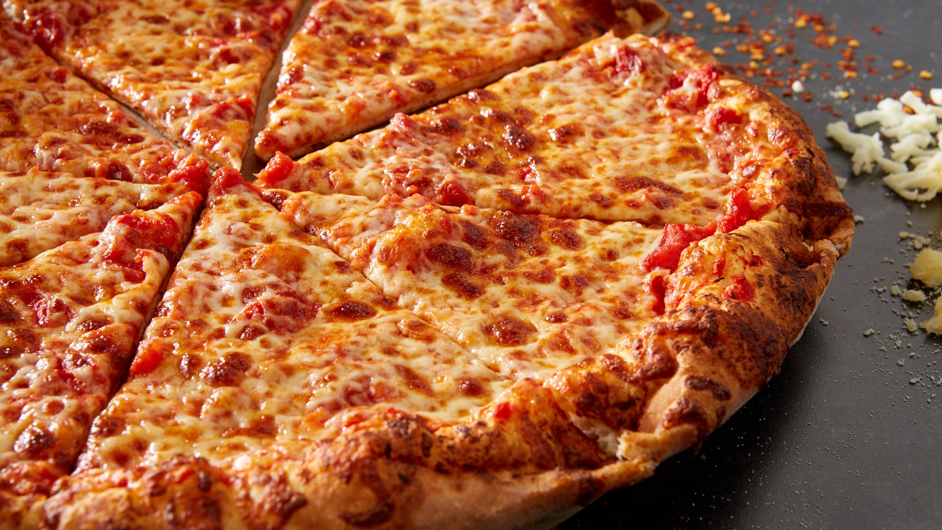 Close-up of Sal’s Pizza Orlando cheese pizza with melted mozzarella and golden crust.