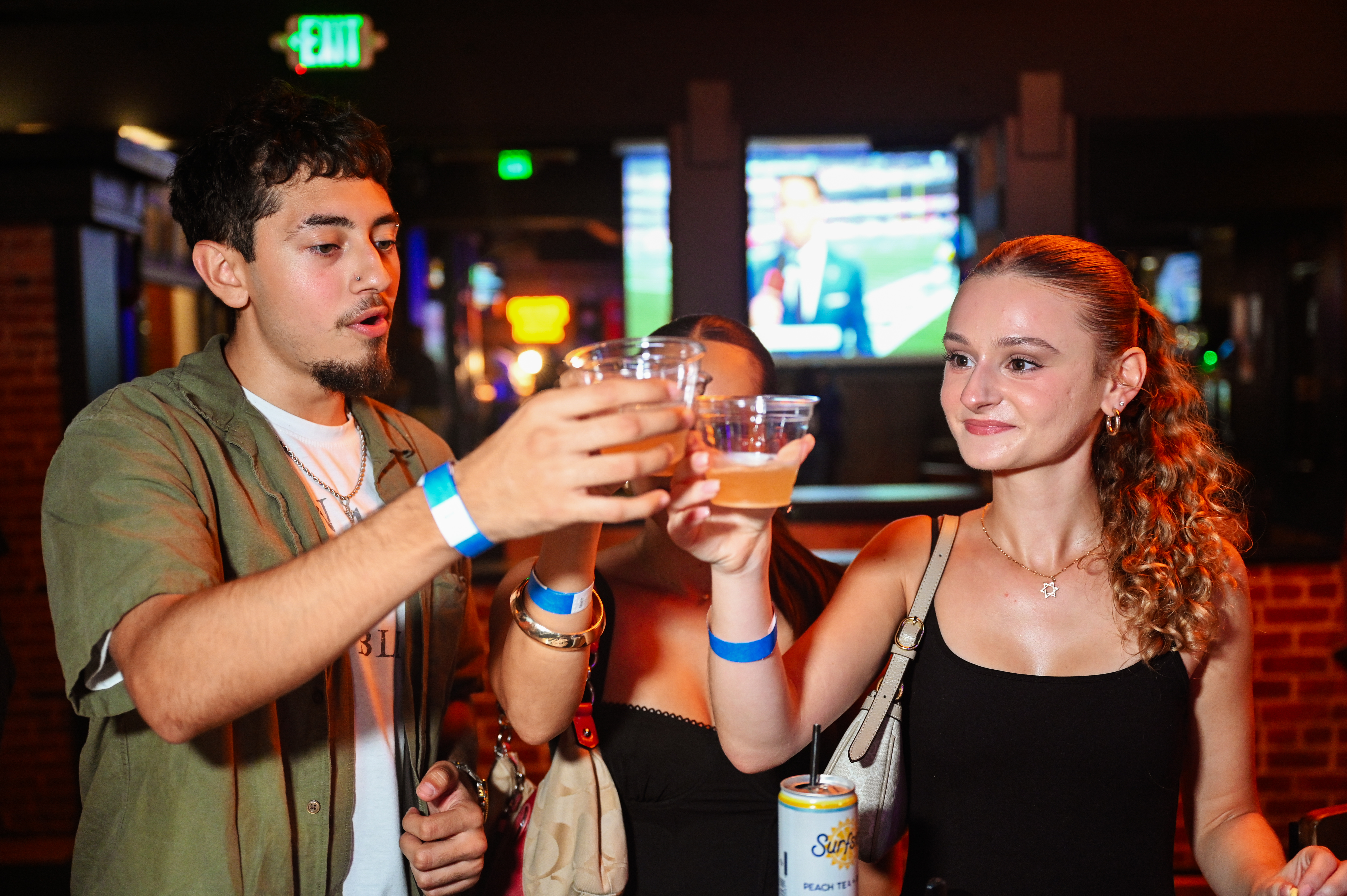 3 people cheersing with deep eddy bombs