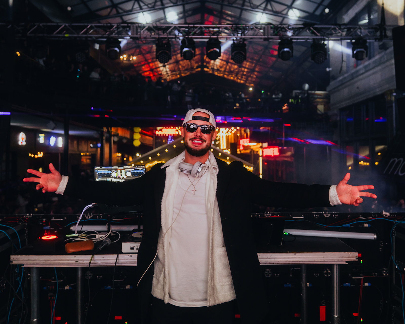 DJ Scooter on the main stage, facing the camera with his hands held wide