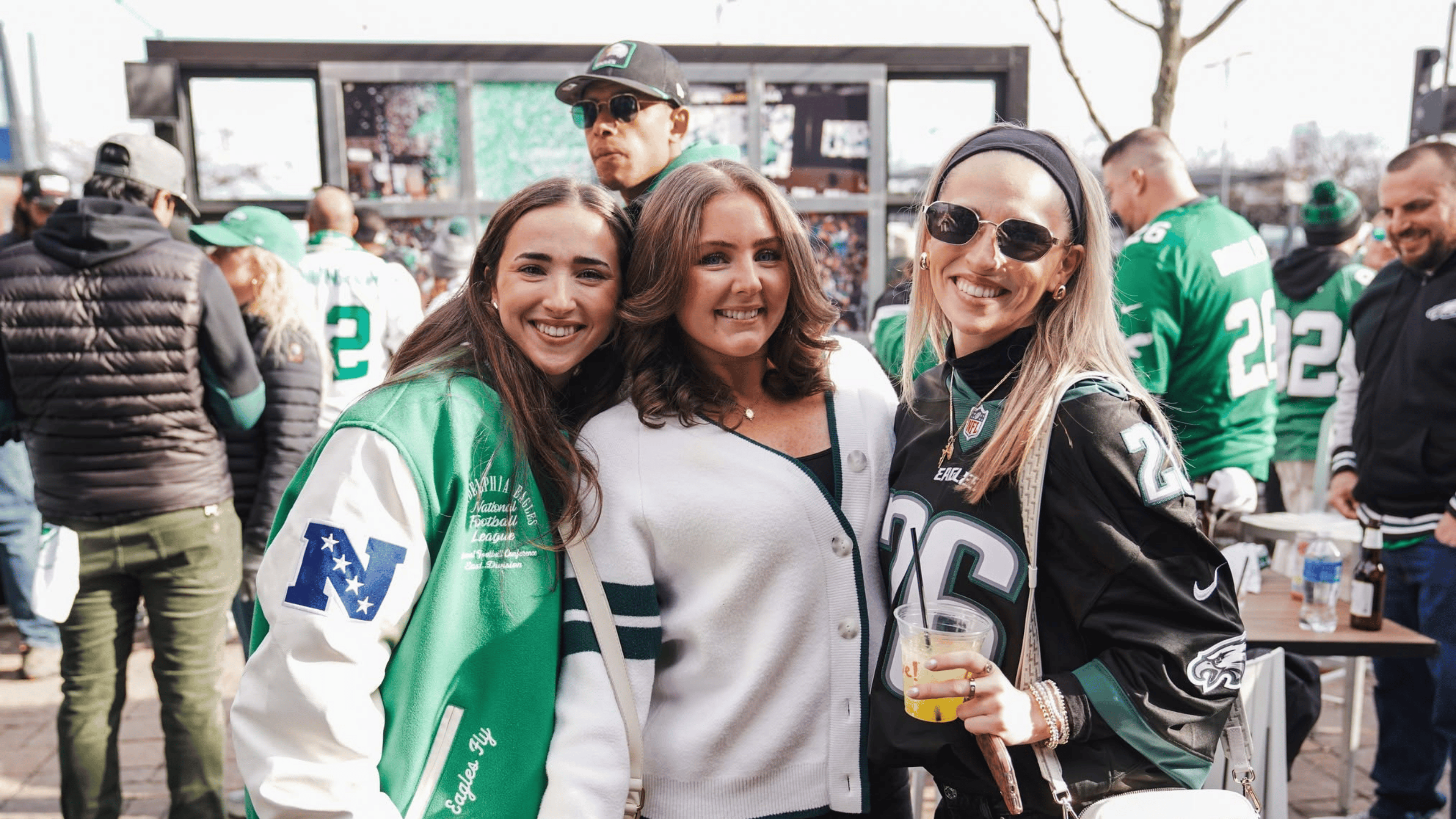 3 girls smiling at tailgate