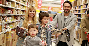 Parents and two children in shopping cart.