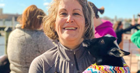 Woman holding baby goat.
