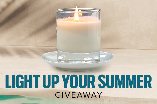 white candle, lit, on a cream background