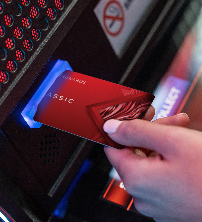 a player inserting their live rewards card into a machine