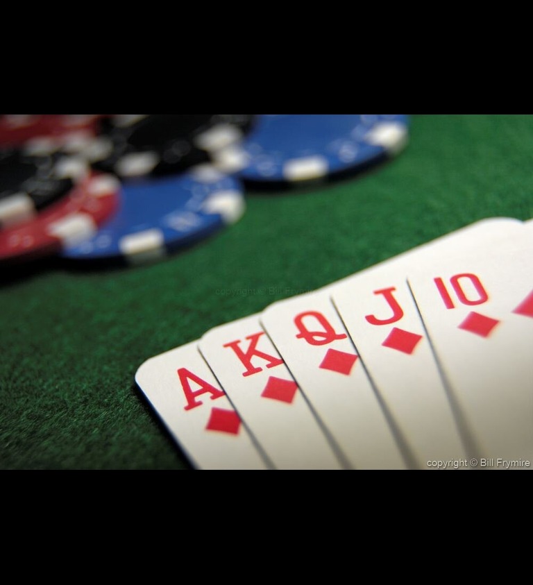 diamond flush in poker cards on a felt table with poker chips in the background