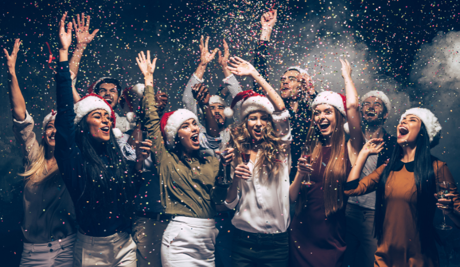Group of people partying in santa hats