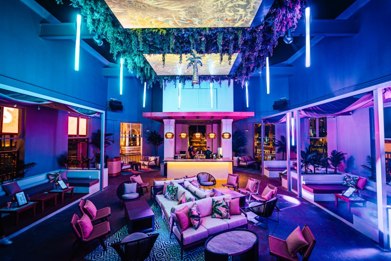 Palm Tree Club lounge and bar with evening mood lighting at Live! at the Pointe Orlando.