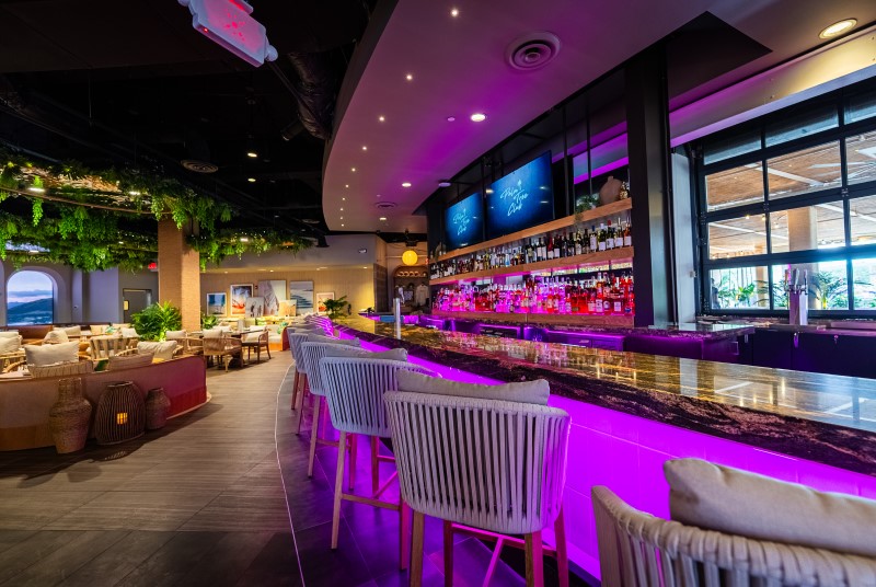 Palm Tree Club restaurant bar adjacent to dining area at Live! at the Pointe Orlando.