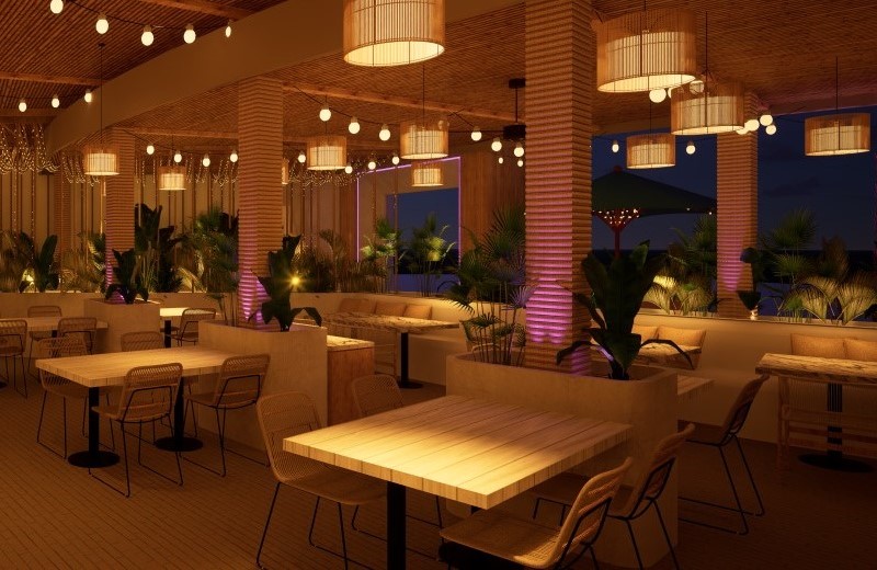 Patio dining area at night at Palm Tree Club.