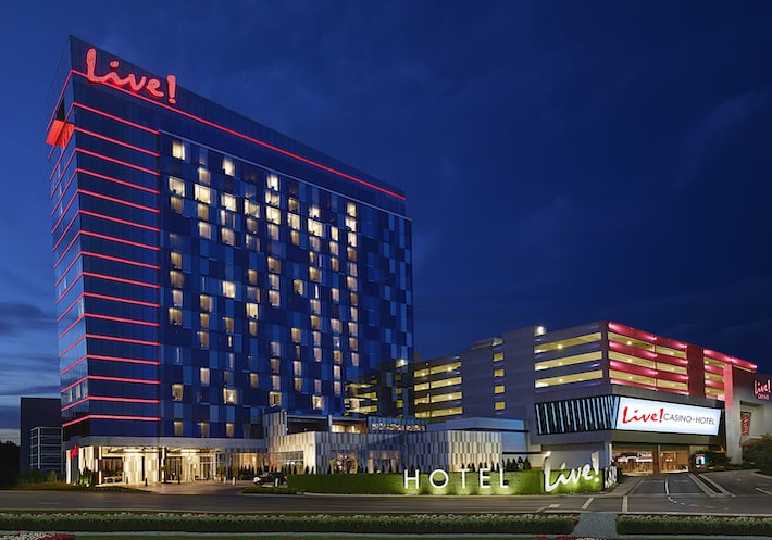 The sparkling red Live! logo and red lights along each floor of the Maryland Casino & Hotel stand out against the night sky.