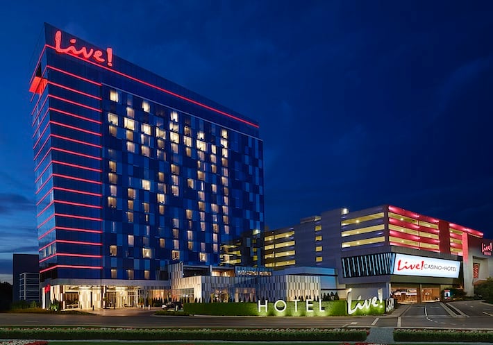 The sparkling red Live! logo and red lights along each floor of the Maryland Casino & Hotel stand out against the night sky.