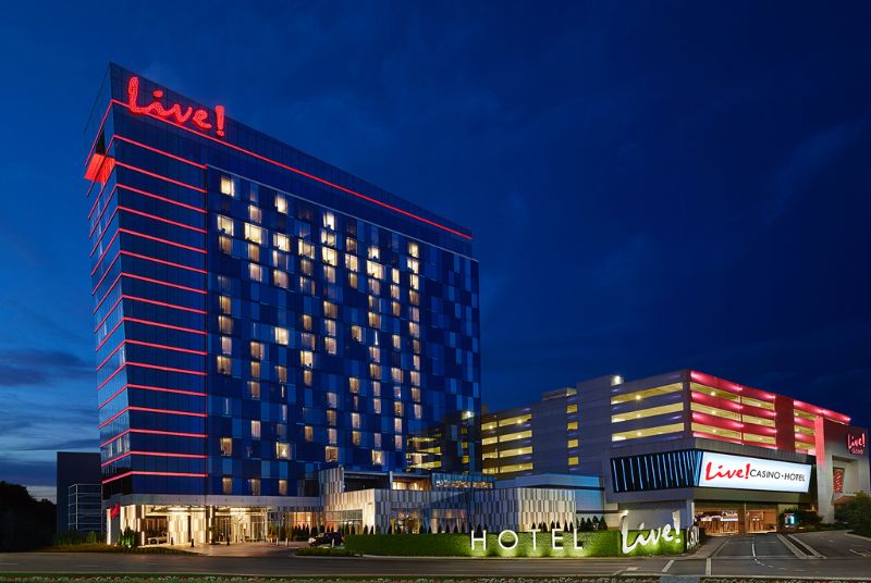 The sparkling red Live! logo and red lights along each floor of the Maryland Casino & Hotel stand out against the night sky.