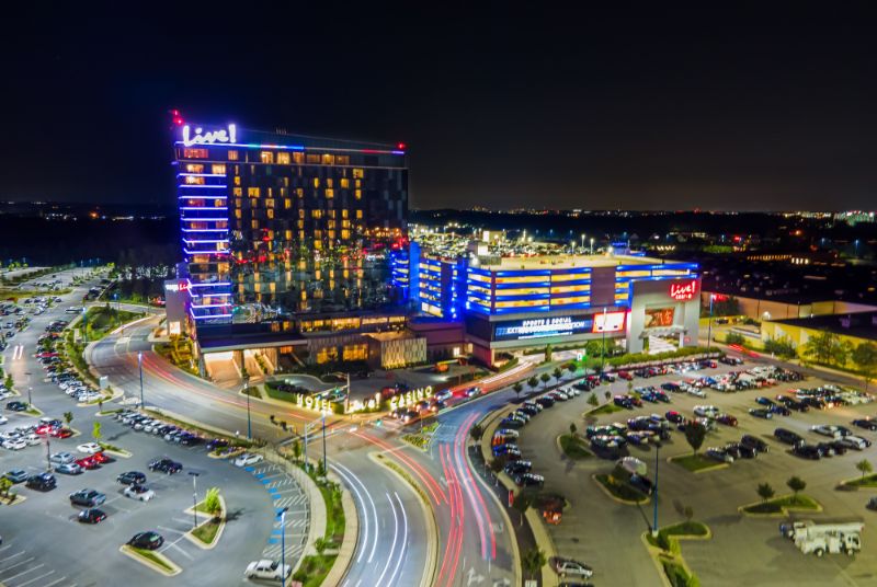 A time-lapse view of the car lights and city night around the beautiful blue-lit Live! Casino & Hotel.