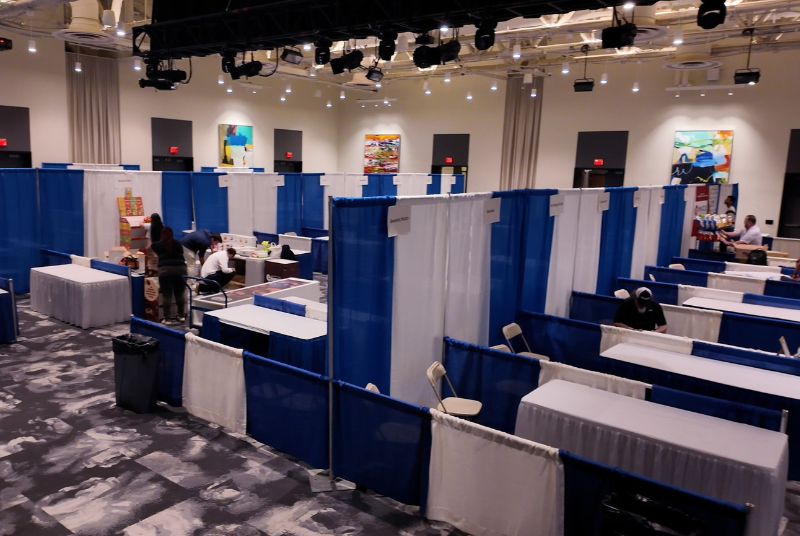 Image of a conference room set-up in a U-shape with an image of some catering food items and a separate Trade show event being set-up