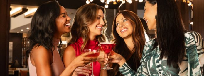 image of women clinking martini glasses together at ridotto bar