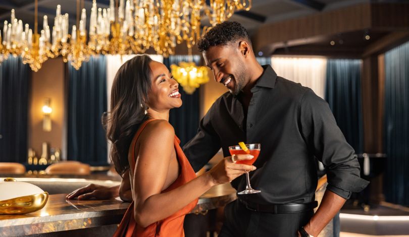 image of a couple enjoying drinks at the bar at prime rib louisiana