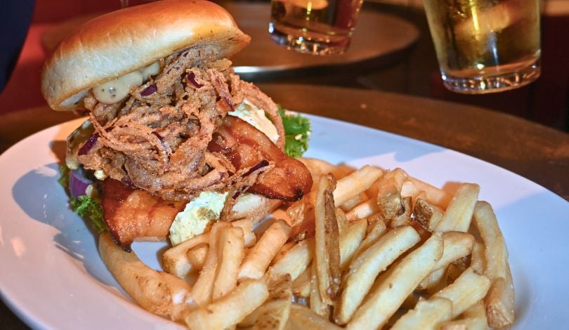 image of a jalapeno popper burger from sports & social louisiana