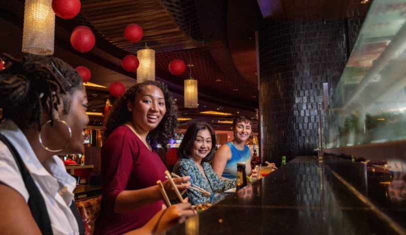 image of people sitting at the sushi bar at luk fu louisiana