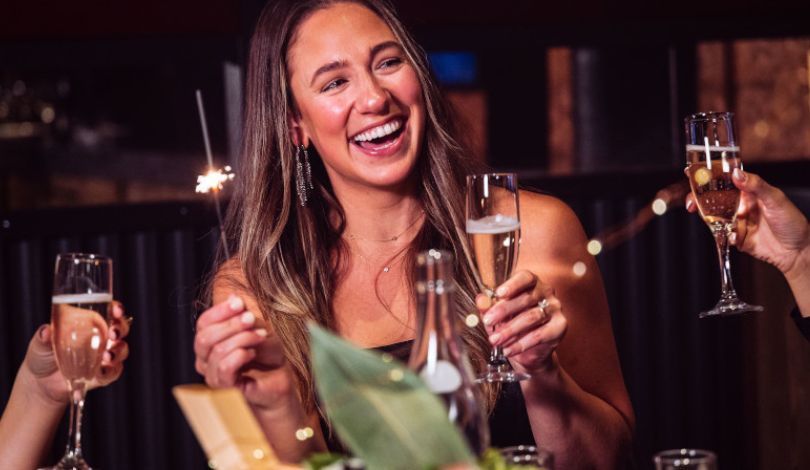 image of people celebrating with sparklers and champagne glasses