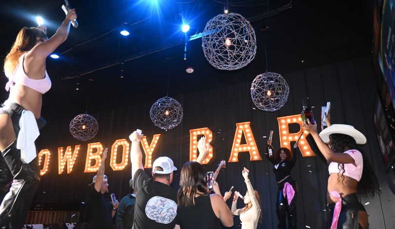 image of people celebrating in a vip booth at pbr louisiana