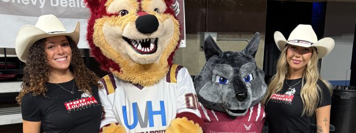 image of 4 people, two are wearing black shirts and cowboy hats, the other two are mascot costumes wearing louisiana rouxgaroux arena football jerseys