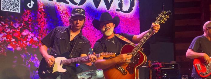 image of two men playing instruments on a stage