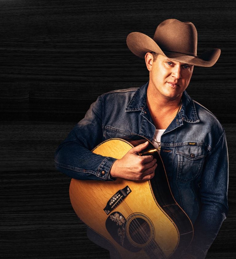 a wooden background with a photo of a man holding a guitar