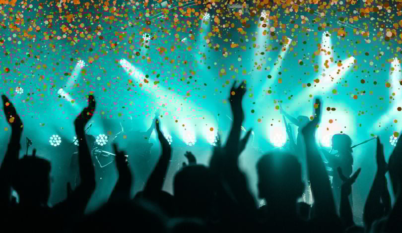image of a party with blue lights and orange glitter