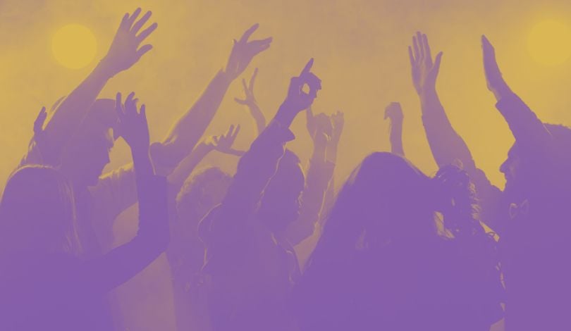 purple and gold image of people dancing