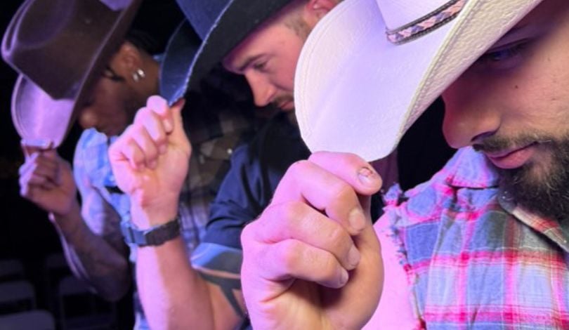 image of three men in a row tipping their cowboy hats