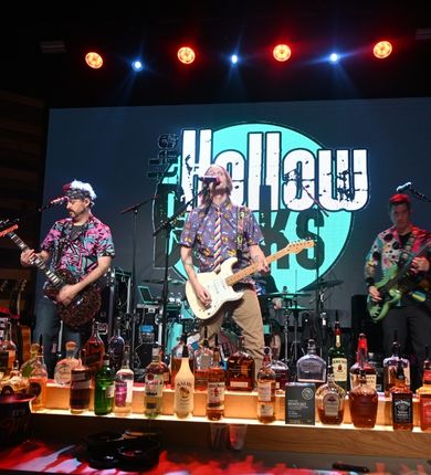 image of the hollow decks performing at pbr. 3 men on stage playing guitars