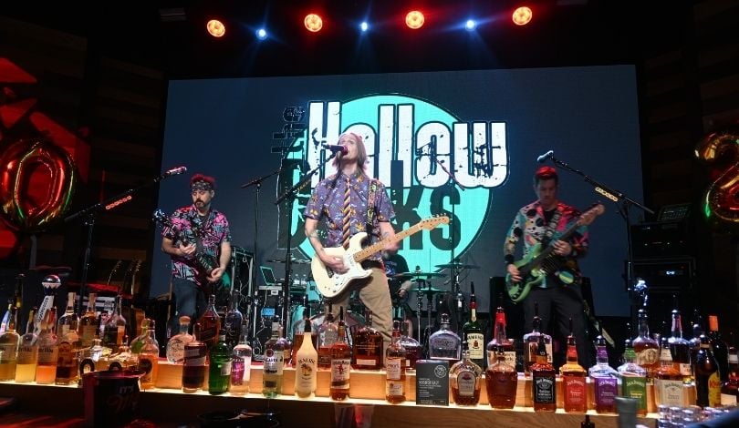 image of the hollow decks performing at pbr. 3 men on stage playing guitars