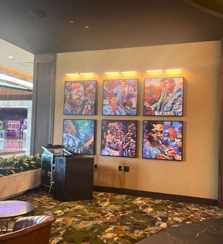 image of a white wall and green patterned floor with 6 photos on the wall