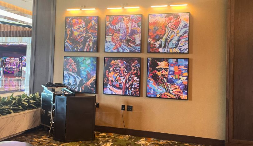 image of a white wall and green patterned floor with 6 photos on the wall