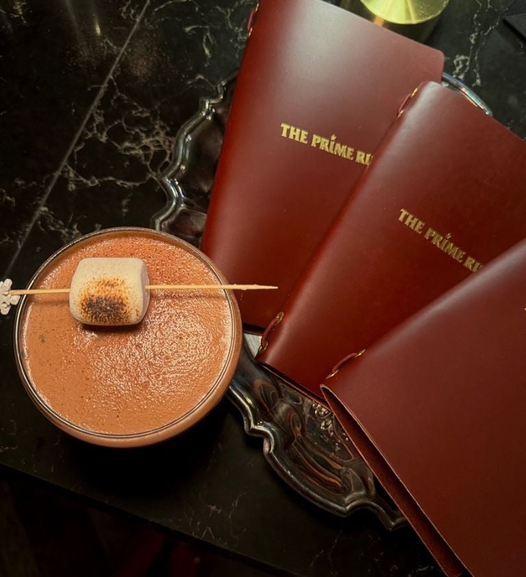image of a cocktail and 3 red menu books