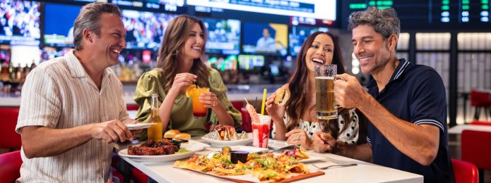 image of people drinking and eating at sports & social louisiana
