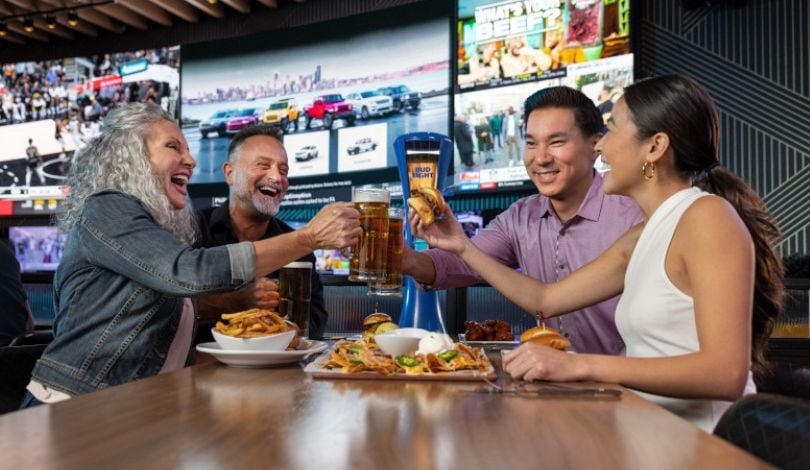 photo of group enjoying meal at sports & social