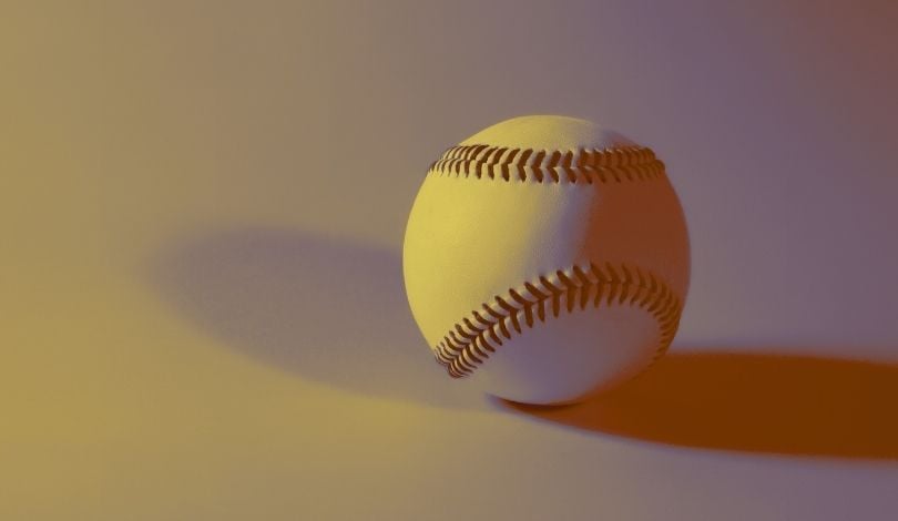 image of a baseball with purple and gold tones