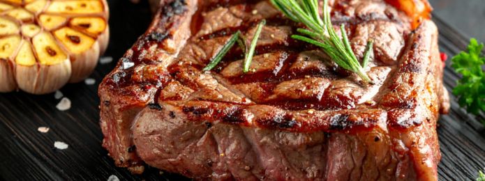 image of a cooked steak on a wooden plate