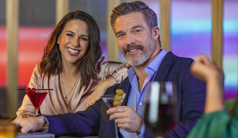 image of man and woman holding martinis in martini glasses