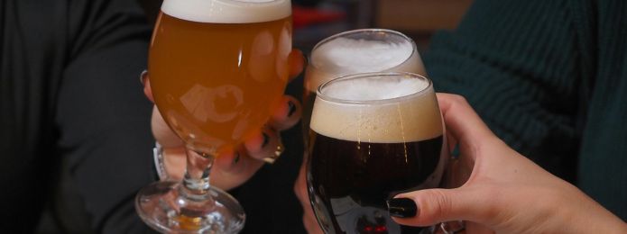 image of people clinking beer glasses together