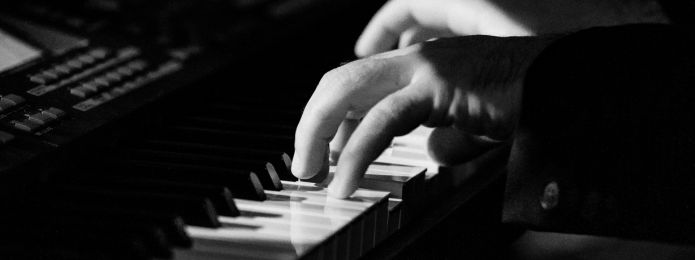 black and white image of someone playing piano