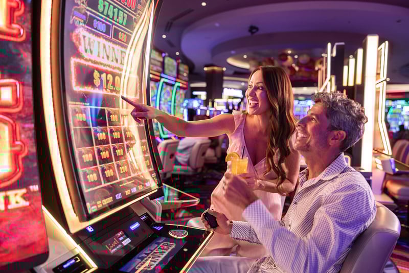 Couple playing at a slot machine
