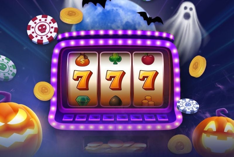 Slot machine that has purple lights on the outside rim of it, display three 7's. Surrounded by poker chips with skulls on them, bats, and ghosts.