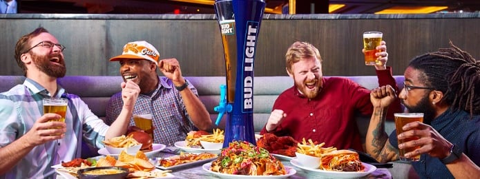 fans at a table eating food and cheering