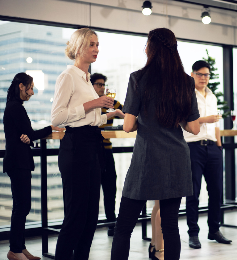 People in business casual ware drinking cocktails 